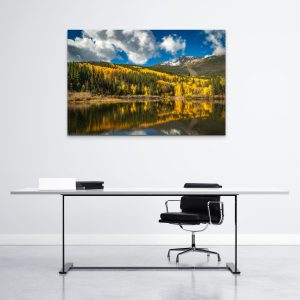 A scenic mountain photograph during autumn, featuring snow-capped peaks and vibrant aspen trees in a office.