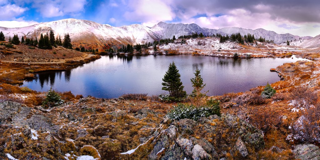 A rugged mountain amphitheater  surrounds this high-alpine lake in Colorado. Fine Art Photographer Clark Schiring captured this panoramic scene on his Sony Alpha digital Camera.